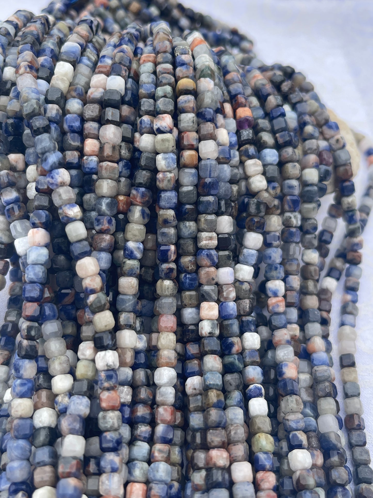 Sunset Sodalite ( 6x6mm faceted cube shape)